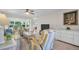 Bright living room features a comfortable seating arrangement and a seamless flow into the dining area at 908 Rosewood Ln, Palm Harbor, FL 34684