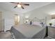 Main bedroom with a walk-in shower visible from the bed; features a ceiling fan and neutral color palette at 908 Rosewood Ln, Palm Harbor, FL 34684