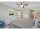 Main bedroom featuring neutral colors, a ceiling fan, and dressers for storage at 908 Rosewood Ln, Palm Harbor, FL 34684