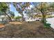 The spacious backyard features mature trees, a fire pit, and room for outdoor activities at 910 Edgedale Cir, Brandon, FL 33510