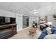 Finished basement offers a cozy den, neutral flooring, and a sliding glass door to additional living space at 910 Edgedale Cir, Brandon, FL 33510