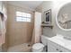 Neutral bathroom featuring a tiled shower stall with a curtain, a floating shelf, and a white vanity at 910 Edgedale Cir, Brandon, FL 33510