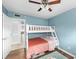 Bright ' bedroom with a bunk bed, blue walls, and a cozy rug on wood flooring at 910 Edgedale Cir, Brandon, FL 33510