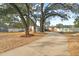 A quaint home with mature trees, brick accents, and a driveway leading to its welcoming entrance at 910 Edgedale Cir, Brandon, FL 33510