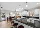 Modern kitchen with granite countertops, stainless steel appliances, and an adjacent dining area at 910 Edgedale Cir, Brandon, FL 33510
