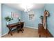 Bright home office space with light blue walls, a desk with rolling chair, and a window providing natural light at 910 Edgedale Cir, Brandon, FL 33510