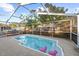 Inviting screened-in swimming pool in a private backyard, with pink flamingo floaties in the water at 910 Edgedale Cir, Brandon, FL 33510