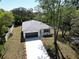 Aerial view of a single-Gathering home featuring a long driveway and mature trees at 9445 Eldridge Rd, Spring Hill, FL 34608