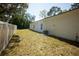 Spacious backyard with a well-maintained lawn and a light-colored fence, ideal for outdoor activities at 9445 Eldridge Rd, Spring Hill, FL 34608