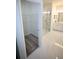 Bathroom boasts a glass shower enclosure, dual sink vanity, and marble tile flooring at 9445 Eldridge Rd, Spring Hill, FL 34608
