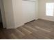 A bright bedroom with wood-look floors and a double closet for storage at 9445 Eldridge Rd, Spring Hill, FL 34608