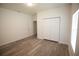 Bright bedroom featuring wood-look floors, double closet, and neutral paint at 9445 Eldridge Rd, Spring Hill, FL 34608