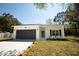 Charming single-story home featuring a modern exterior, well-kept lawn, and a two-car garage at 9445 Eldridge Rd, Spring Hill, FL 34608