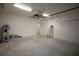 Open two-car garage with ample storage space, featuring a water heater and an additional room at 9445 Eldridge Rd, Spring Hill, FL 34608