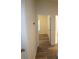 Hallway leading to various rooms, showcasing modern flooring and neutral wall colors at 9445 Eldridge Rd, Spring Hill, FL 34608