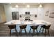 Modern kitchen featuring a large island with barstool seating and stainless steel appliances at 9445 Eldridge Rd, Spring Hill, FL 34608