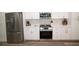 Well-equipped kitchen showcasing stainless steel appliances, white cabinetry, and modern finishes at 9445 Eldridge Rd, Spring Hill, FL 34608