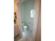 Powder room featuring toilet and vanity with white marble floors and light bright paint at 9445 Eldridge Rd, Spring Hill, FL 34608