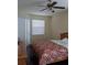 Comfortable bedroom with a ceiling fan, window with blinds, and a cozy bed at 9636 Greenbank Dr, Riverview, FL 33569