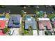 Aerial view of a house with a pool and dock, with neighboring houses and water access at 9826 Island Harbor Dr, Port Richey, FL 34668