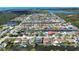 Wide aerial shot showcasing a dense waterfront community with canals, homes, and tropical foliage under a clear sky at 9826 Island Harbor Dr, Port Richey, FL 34668