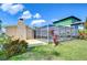 Backyard view showcasing pool with enclosure, chimney, and grassy lawn, perfect for entertaining at 9826 Island Harbor Dr, Port Richey, FL 34668