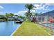 Beautiful backyard view features a pool, dock, and canal access, perfect for relaxing and enjoying waterfront living at 9826 Island Harbor Dr, Port Richey, FL 34668