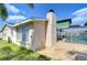 View of backyard with patio, chimney, and screened in pool, creating a relaxing outdoor space at 9826 Island Harbor Dr, Port Richey, FL 34668