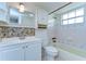 Bathroom features a tub and shower combination, white vanity, and tiled walls at 9826 Island Harbor Dr, Port Richey, FL 34668