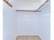 This walk-in closet has carpet, shelving, and rods for organized storage at 9826 Island Harbor Dr, Port Richey, FL 34668