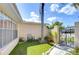 View of the home's entrance with tropical plants and small garden area at 9826 Island Harbor Dr, Port Richey, FL 34668