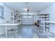 Empty garage, shelves and tables make this space easily customizable at 9826 Island Harbor Dr, Port Richey, FL 34668