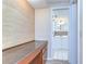 Hallway desk area leading to a bathroom with neutral decor and white cabinets at 9826 Island Harbor Dr, Port Richey, FL 34668