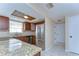 The kitchen features stainless steel appliances, wood cabinets, and tiled floors at 9826 Island Harbor Dr, Port Richey, FL 34668