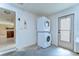 Convenient laundry area with a stacked washer and dryer unit at 9826 Island Harbor Dr, Port Richey, FL 34668