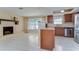 Open concept living room and kitchen featuring a brick fireplace and stainless steel appliances at 9826 Island Harbor Dr, Port Richey, FL 34668