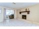 Bright living room with tile flooring, brick fireplace, and sliding glass door to outdoor space at 9826 Island Harbor Dr, Port Richey, FL 34668
