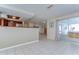 Open living area featuring tile flooring, a sliding door to the patio, and kitchen access at 9826 Island Harbor Dr, Port Richey, FL 34668