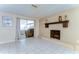 Bright living room boasts tile flooring, fireplace, and sliding doors to the outdoor area at 9826 Island Harbor Dr, Port Richey, FL 34668
