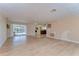 Expansive living room with lovely laminate flooring, fireplace, and pool view at 9826 Island Harbor Dr, Port Richey, FL 34668