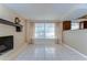 Living room has a brick fireplace, tile floors, and windows letting in natural light at 9826 Island Harbor Dr, Port Richey, FL 34668