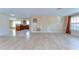 Open-concept living room boasts wood floors, decorative wall, and an adjacent kitchen at 9826 Island Harbor Dr, Port Richey, FL 34668