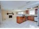 Combination kitchen and living room with island and a cozy brick fireplace at 9826 Island Harbor Dr, Port Richey, FL 34668