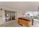 Covered outdoor patio with a hot tub and access to the home through sliding glass doors at 9826 Island Harbor Dr, Port Richey, FL 34668