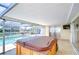 Enjoy this covered patio with a hot tub overlooking the pool and canal at 9826 Island Harbor Dr, Port Richey, FL 34668
