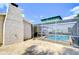Screened-in pool area accessible from the home and patio, with a textured stucco wall at 9826 Island Harbor Dr, Port Richey, FL 34668