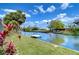 Serene waterfront view highlighting the canal with dock, lush greenery, and peaceful setting at 9826 Island Harbor Dr, Port Richey, FL 34668