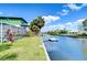 Charming home with waterfront view with canal, private dock, and lush landscape in the backyard at 9826 Island Harbor Dr, Port Richey, FL 34668