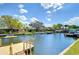 Waterfront landscape view showing canal with dock, lush greenery, and canal, a true boater's paradise at 9826 Island Harbor Dr, Port Richey, FL 34668
