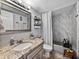 Bathroom boasts hexagon tile floor, granite countertops and decorative tile in the shower at 7910 Sun Island S Dr # 301, South Pasadena, FL 33707
